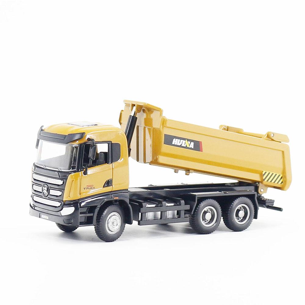 A toy dump truck with a earthy yellow body, black cab, and gray chassis.